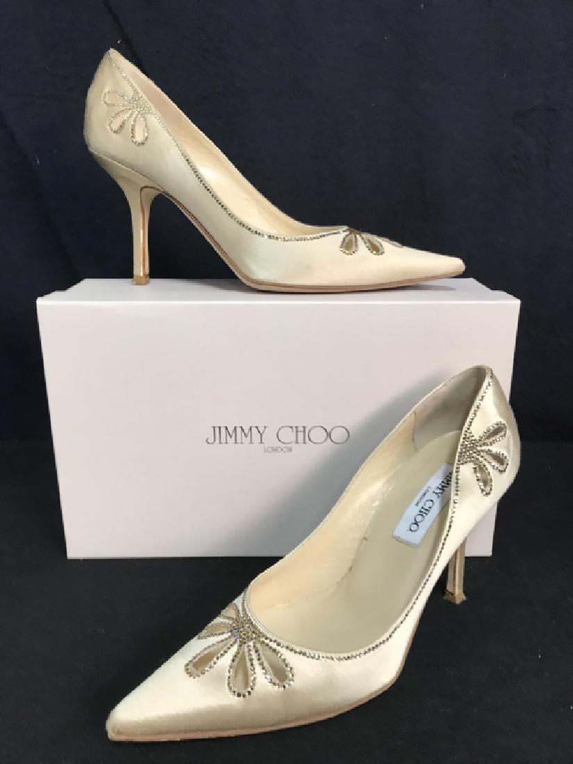 Pair JIMMY CHOO Nude Silk Satin W Rhinestone Shoes: Pair Authentic JIMMY CHOO Nude Silk Satin W Rhinestone Shoes. A pair of Jimmy Choo high heeled shoes in nude silk satin w clover cutouts, trimmed in Rhinestones size 38. Marked on underside Jimmy Choo