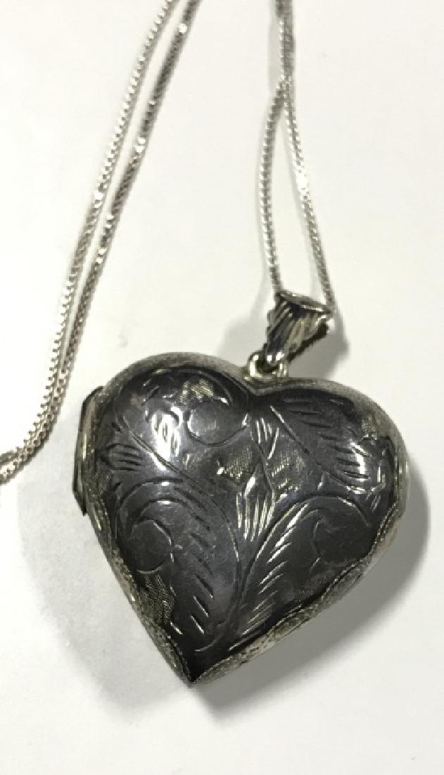 Sterling Silver Etched Heart Locket And Chain: Sterling Silver Etched Heart Locket And Chain. Chain and heart marked 925, etched with filigree motif, opens on hinge, chain measures approx 13 in long. Vintage estate Sterling jewelry 4
