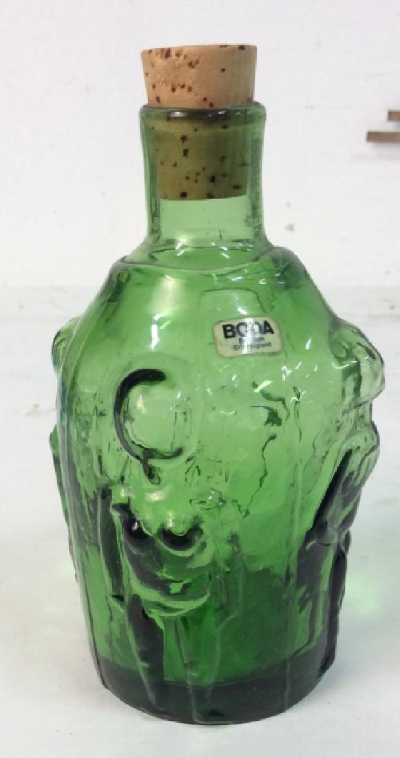 BODA Sweden Green Art Glass Bottle: Vessel, bud vase, green art glass marked for BODA, marked for Erik HOGLUND, measures ht app 6.5 inches male and female nude Figurals in relief. Decorative tabletop decor, tabletop accessory, collectib