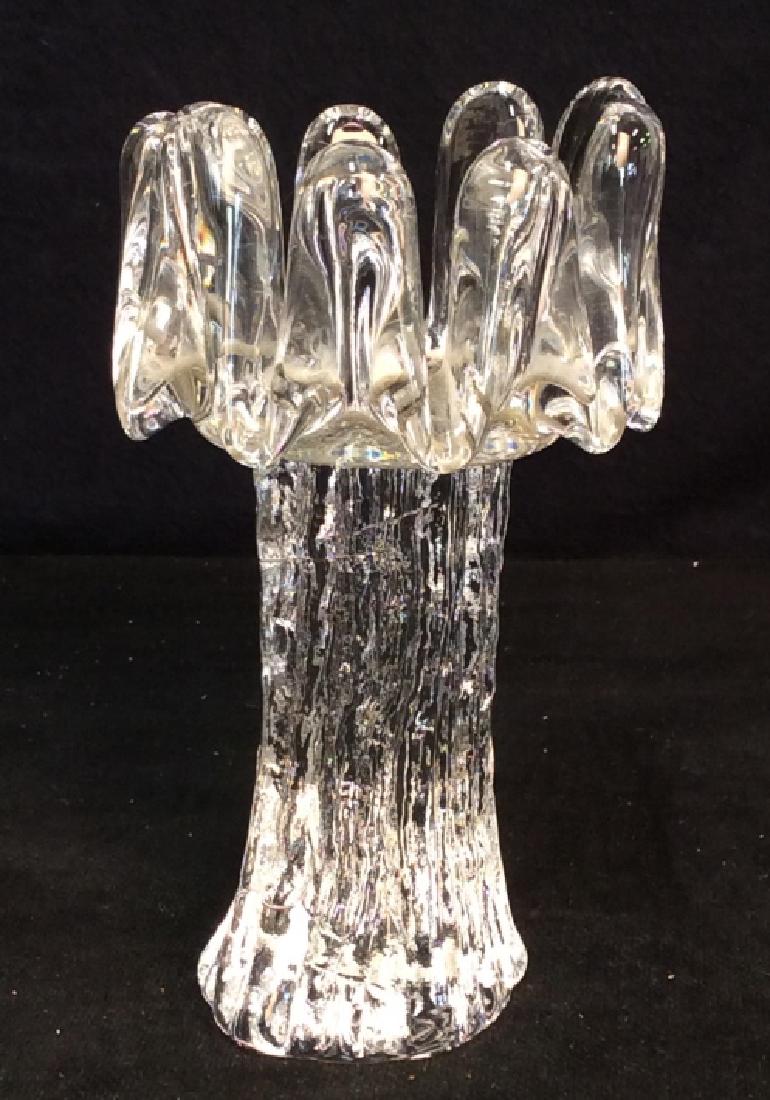 Tall Glass Candle Holder In ‘Sunflower’ Design: Tall glass candle holder In ‘Sunflower’ Design. Crenellated, smooth petals grow out of a solid, textured stem, center is stippled. Possibly Goran Warff for Kosta Sweden design (unmarked). Art Glas