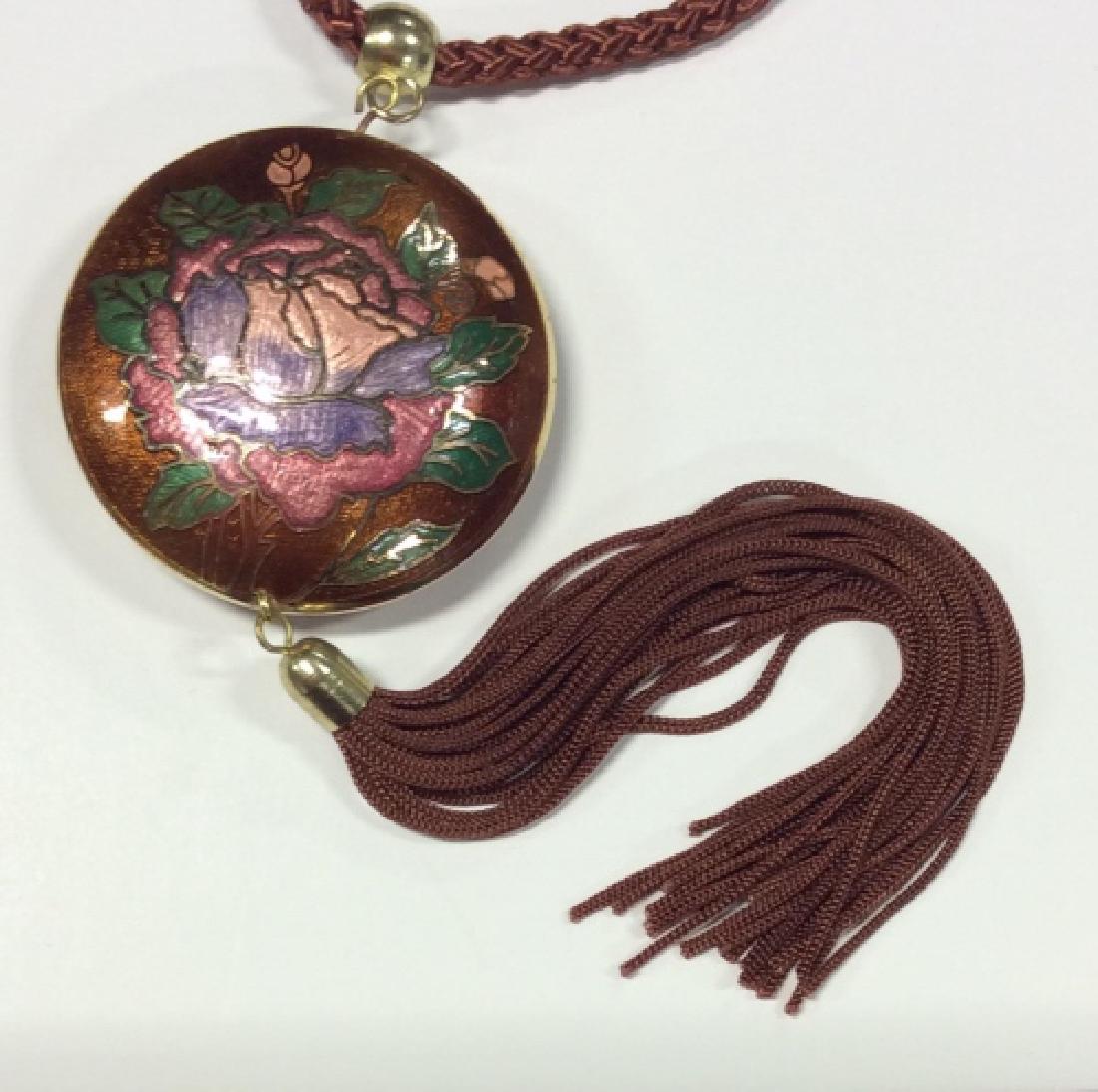 Vintage Cloisonné Floral Pendant: Vintage Cloisonné Floral Pendant With tassel. Bright jewel toned enamel cloisonné pendant with brown toned string and tassel design. Measures approx 20 in long. Women’s vintage jewelry, fashion ac