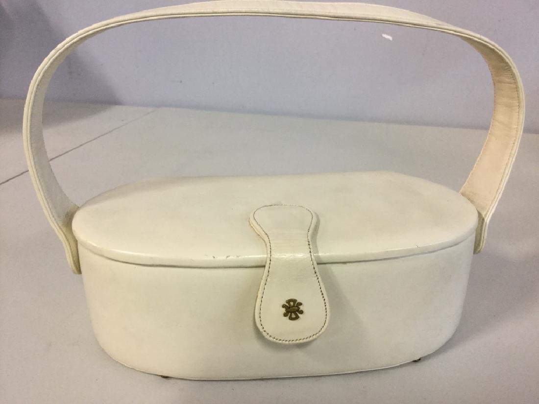 White Leather Coblentz Ladies Pillboc handbag: Handbag White Leather Coblentz Ladies Oval Shaped Illbox Handbag, with single handle, and snap and flap closure with metal makers mark on front flap, 10 x 3 x 4 in deep, creamy white calf leather, nav