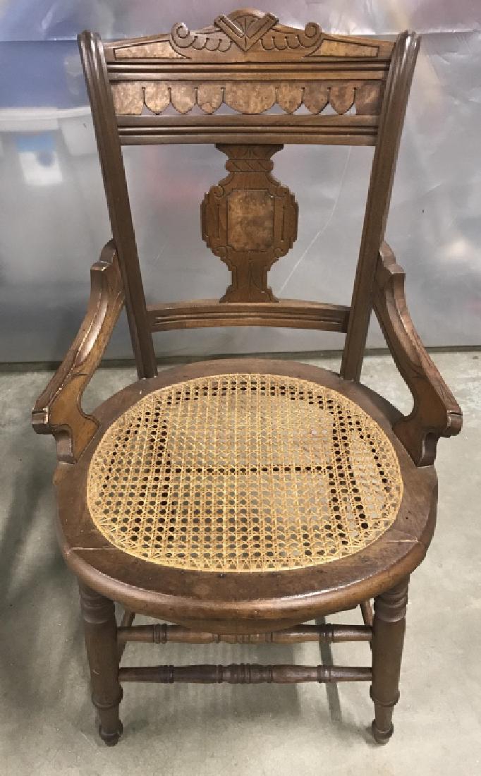 Vintage Carved Wooden Seat: Vintage Carved Wooden seat with caned details. Back of seat is carved in Art Deco style. Round caned seat bottom. Small elbow rests with carved details. Minor fading of the wood consistent with age an