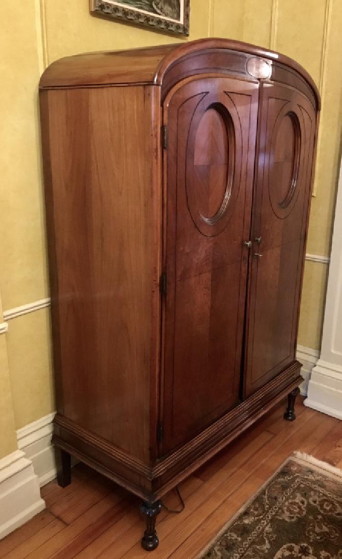 Walnut Toned Vintage Armoire W Four Footed Base: Walnut Toned Vintage poss antique Armoire W rounded top, Four Footed Base, circular front design, five interior drawers, and five interior shelves. Vintage Clothes storage. Walnut Toned Armoire, Cabin