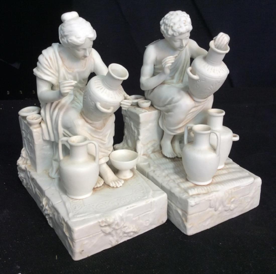 Pair Samson Porcelain Grecian Style Figurals: Seated man and seated woman both crafting pottery jugs, each measures app ht 8.5 inches depth app 7 inches, each has underside marked with crossed arrows for Samson Trademark, decorative accessory, de