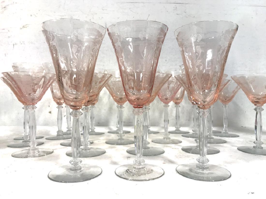 Rose Tinted Etched Drinking & Serving Glasses: Rose tinted drinking glasses and serving dishes with decorative etching. Serving glasses include 12 wine glasses and 11 martini glasses with floral motif etchings. Serving dishes include a large fruit