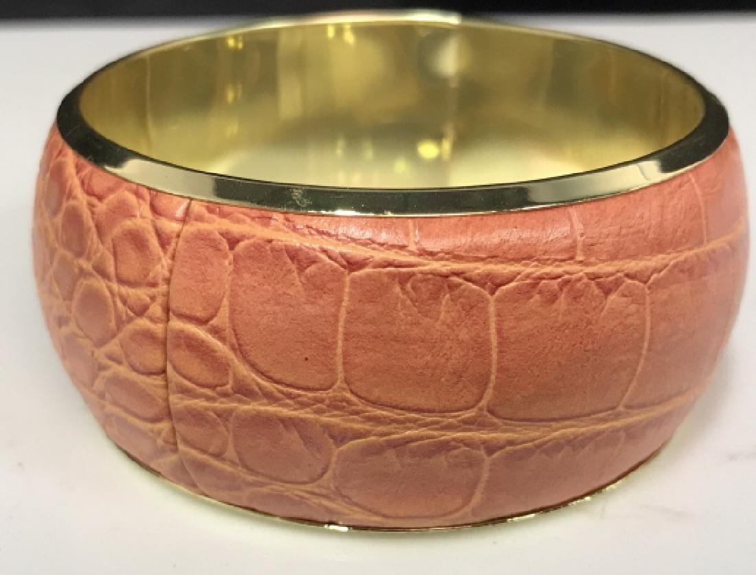 Park Lane Faux Leather / Shagreen Bangle: Park Lane Faux shagreen Bangle, 3 in diameter, in faux coral colored Shagreen and gold toned hardware, With Tag from park lane, jewelry from 1955 women's vintage estate jewelry, fashion accessory, wea