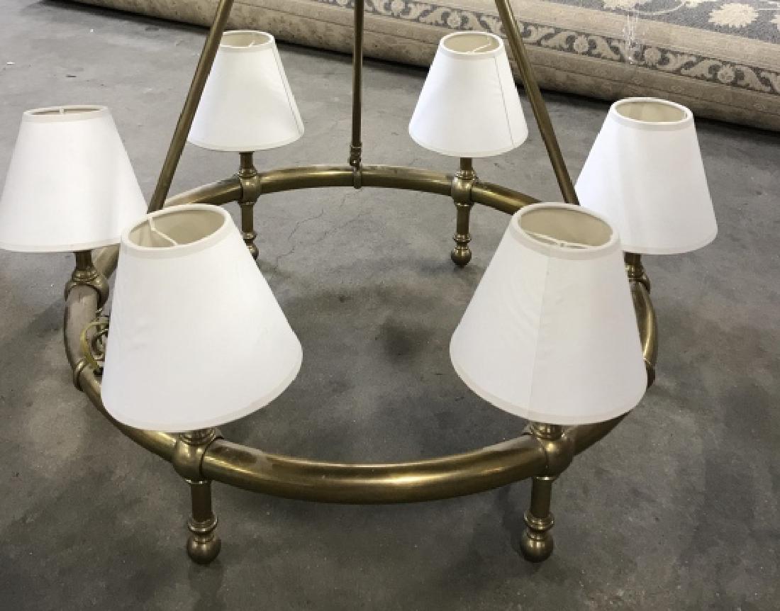 Brass Toned Six Light Metal Chandelier: Brass Toned Six Light Metal Chandelier With cream toned shades. Chandelier not tested. Measures approx 25 inches in diameter x 34 inch drop. Lighting. Chandelier Lighting. Brass Toned Metal Chandelier