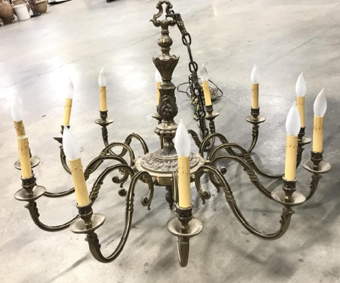 Twelve Armed Brass Toned Chandelier: Twelve Armed Brass Toned Chandelier W S scroll arms, and acanthus leaf design. Grand Staircase Chandelier. Chandelier lighting. Light not tested, needs cleaning. Measures approx 85 inch drop x 37 inch