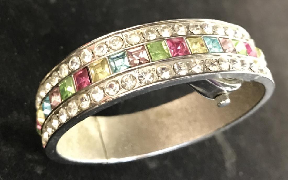 Ladies Fashion Rhinestone Bangle Bracelet Watch: Ladies Park Lane Fashion Rhinestone Bangle Bracelet Watch, diameter 2 3/4 in, 1/2 in width of bangle, one rhinestone missing, spring closure, Manuel, Not tested, underside of watch marked bezel stainl