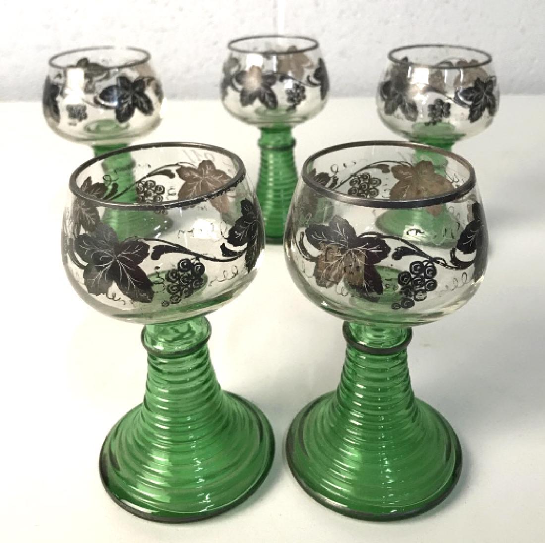 Set 5 Green Glass And Silver Toned Wine Goblets: vintage stemware, table ware, colored glass tableware, Set 5 Green stemmed and Clear Glass wine goblets with Silver Toned vine and grape overlay. Some wear to silver overlay. Measures approx 5 inches 
