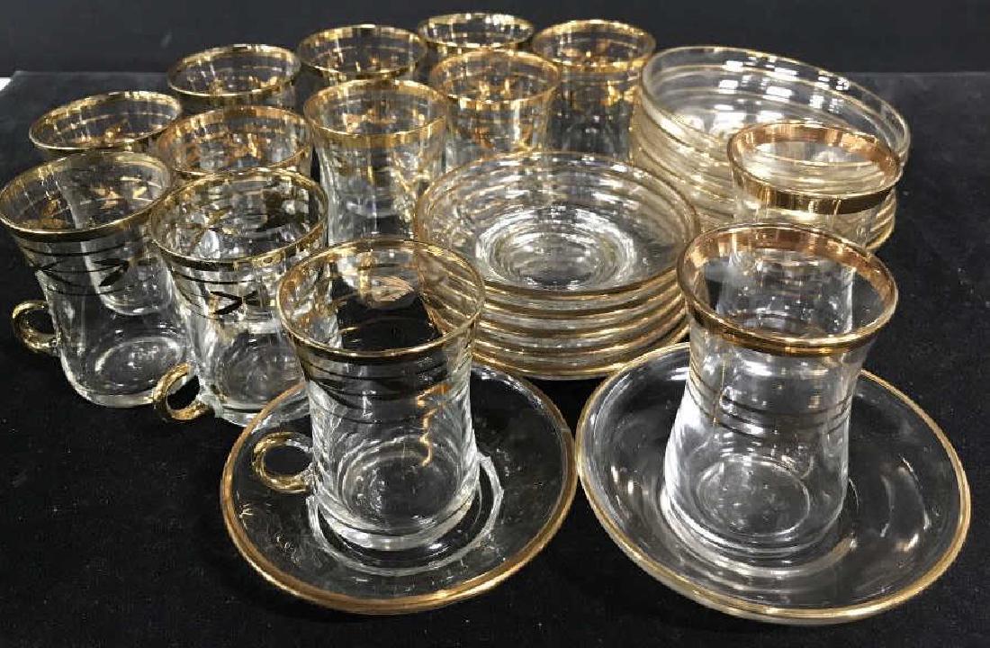 Group of Italian Made Shot Glasses & Saucers: Italian made shot / schnapps / aperitivo glasses and saucers. Group includes 11 glasses with small handles along bottom rim, 2 glasses without handle, 8 flat surface saucers, and 6 slightly textured s