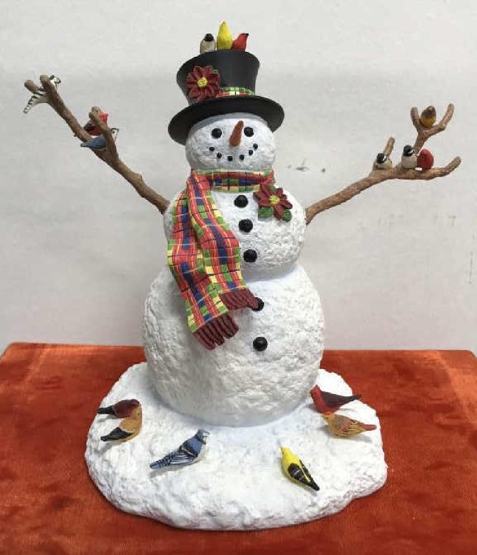 LENOX Ceramic Snowman & Birds Figurine: LENOX Ceramic snowman with birds figurine. A snowman with hat and scarf has birds lined up on its hat, twig arms, and around its base. Underside is marked with LENOX trademark sticker label, with the 