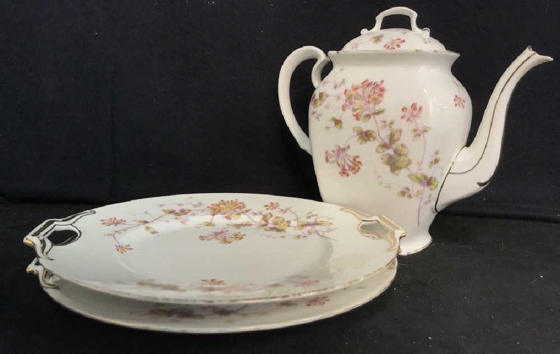 LIMOGES Set of Teapot & 2 Plates: LIMOGES set of teapot & 2 plates. Teapot is tall standing and plates are handled. Each piece has floral pattern with gold tone embellishments. Possibly porcelain. Gold tone is slightly faded on all pi