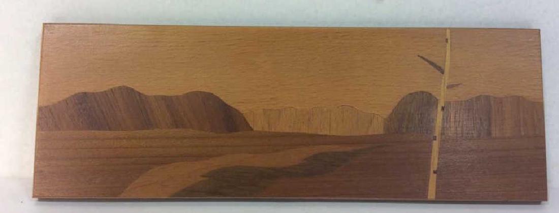 Wood Inlay Artwork Of Birch in Landscape: Wood Inlay artwork of birch in landscape. Russian made, with label sticker on reverse side written in cyrillic / Russian characters. Approximately 4 inches in height by 10.5 inches in width. Vintage w