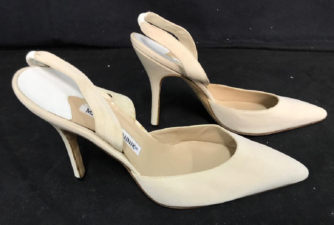 Pair of Vintage MANOLO BLAHNIK Dress Shoes: Pair of vintage authentic luxury designer MANOLO BLAHNIK heeled dress shoes in sling back style. Shoes have leather details and are cream in tone. Shoes have been worn before and have some stains in t