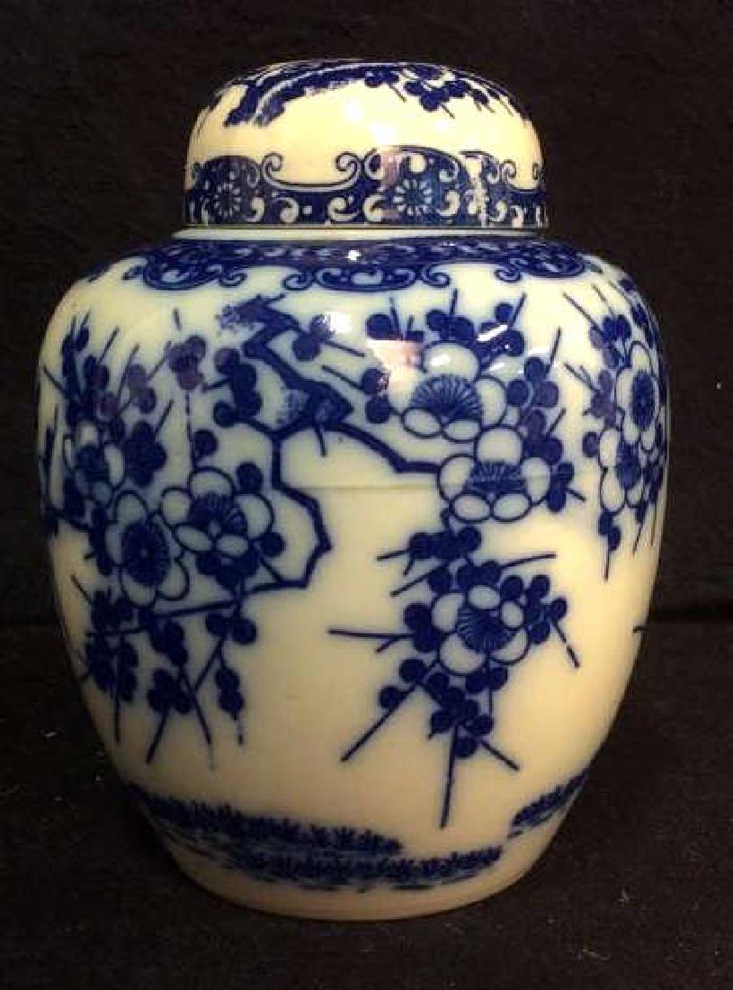 Vintage Japanese Porcelain Ginger Jar / Urn: Vintage Japanese Porcelain Ginger Jar with blue and white tone Cherry Blossom Pattern. Underside has ‘Japan’ sticker label. Some bleeding of the blue glaze. Minor / subtle crack, but could be impe