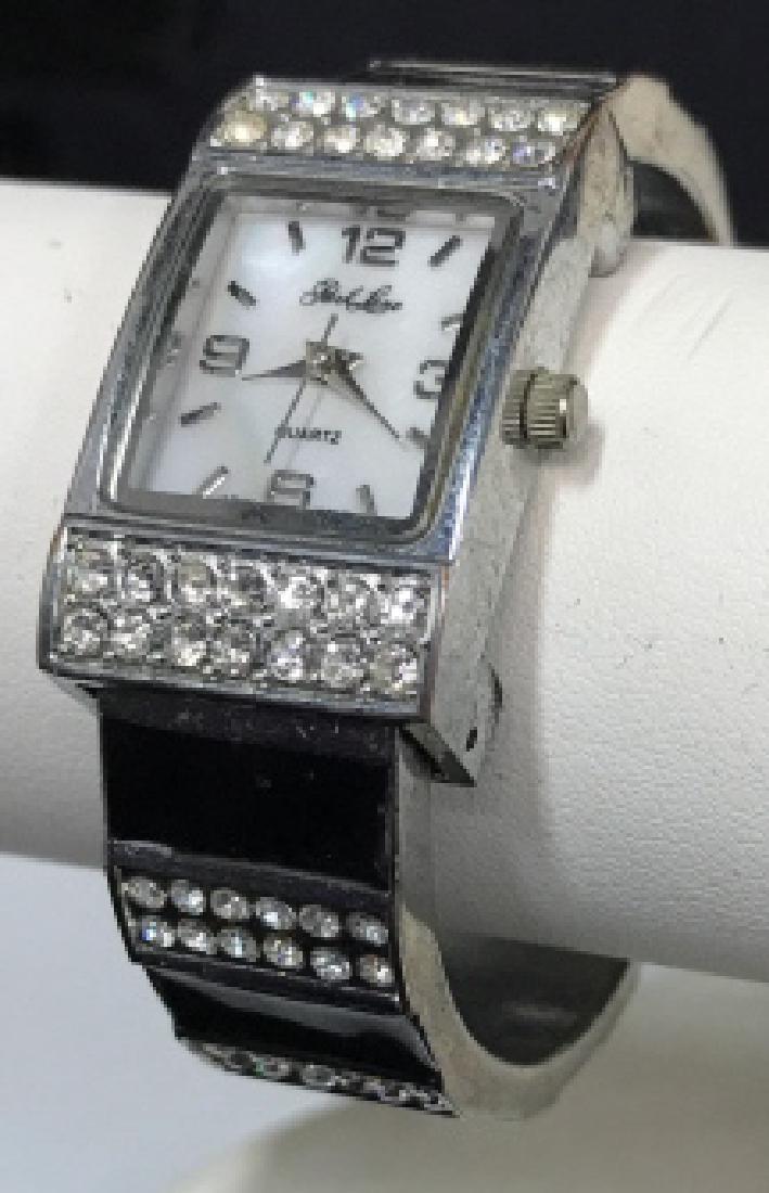 Park Lane Ladies Fashion Watch: Park Lane Ladies Fashion Watch, formed as a silver toned bangle with enamel and rhinestones, face marked park lane quartz, underside marked park lane stainless steel, inside diameter 2 1/8 in, vintage
