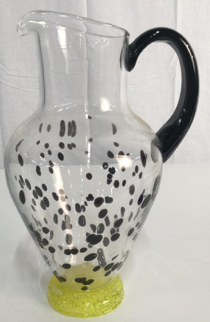 KOSTA BODA Footed Glass Pitcher: Art glass, Vase,vessel, tableware, hand formed, labeled for KOSTA BODA, measures ht app 11 inches, handle to rim 7 inches, decorative table top accessory