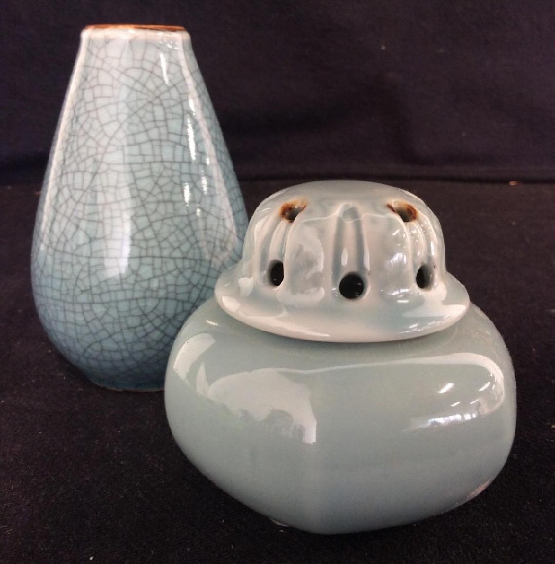 Lot 2 Blue Toned Porcelain Tabletop Accessories: Lot 2 Blue Toned Porcelain Tabletop Accessories. One bud vase with crackle texture design, one lidded censer Incense Burner, Vessel. Tabletop accessories, tableware, decorative accessories. Tallest me