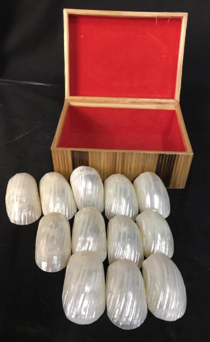 Set 12 Mother Pearl Napkin Rings In Box: Set of 12 mother of Pearl Napkin Rings in Sea Shell Style form, in lidded wood keep sake box. Box measures 5.5 by 4 inches, 3.5 inches ht, each napkin ring, tableware, decorative tabletop accessory, m