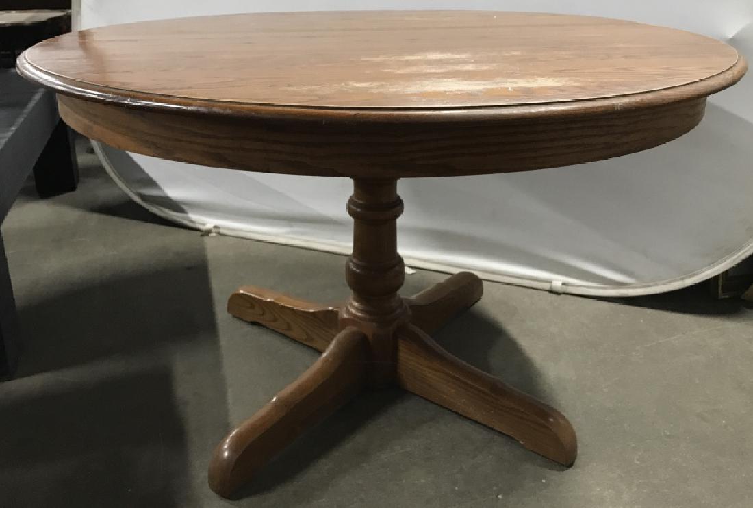 L. Hitchcock Round Oak Pedestal Table: L. Hitchcock Round Oak Pedestal Dining Table W Two Leaves. Has wear to top and small nicks to base. Marked on underside of leaf, L. Hitchcock. Hitchcocksville. Conn. Warranted. Measures approx 48 inch