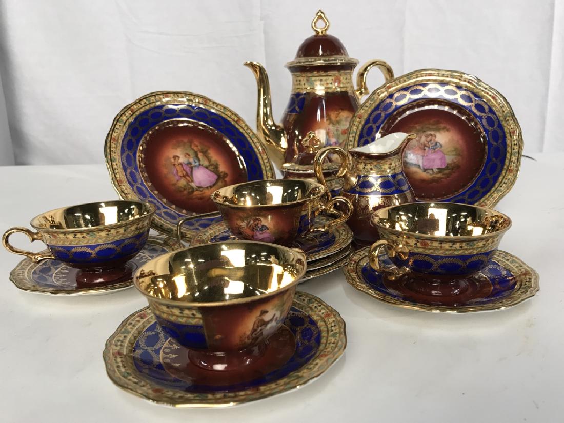 Rosenthal German Tea Set: Rosenthal German Tea Set, including. A Lidded tea pot, 4 cups, 6 saucers, a creamer and a Lidded sugar bowl, 2 bread plates , 15 pieces total, ornate with gold and hand painting of lovers and gold wre