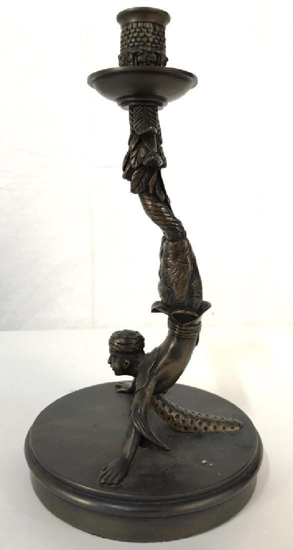 Arabian Acrobat Figural Candlestick: Candlestick depicts an upside down Arabian acrobat doing a handstand. Measures approx 11.5 inches tall 6 inches wide. Piece appears to be brass. Tableware, home decor, tabletop accessory. 6