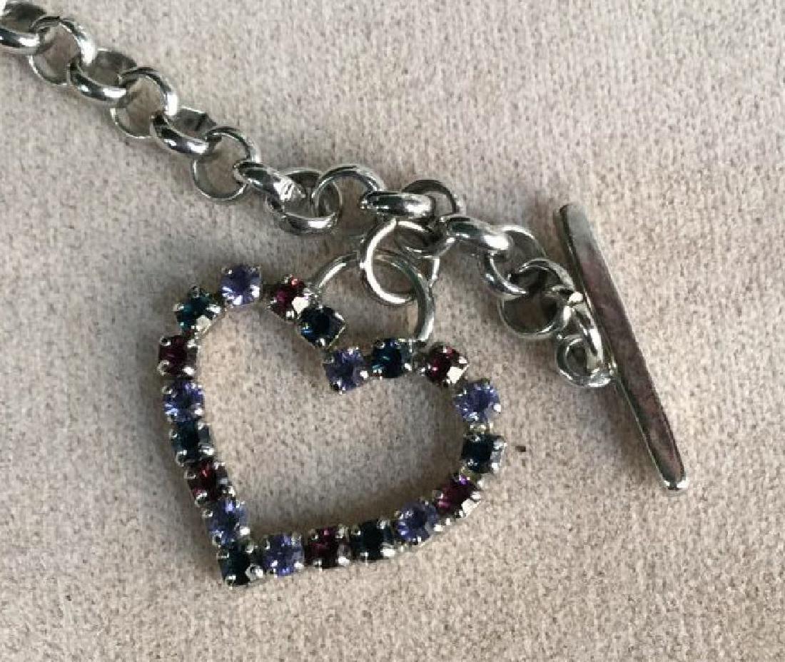 GUESS Rhinestone Heart Pendant Toggle Necklace: GUESS rhinestone heart pendant toggle necklace. Rhinestones are various purple tones. Vintage Jewelry, statement necklace, costume jewelry. Drop from clasp to tip measures approx 8 inches in length. G