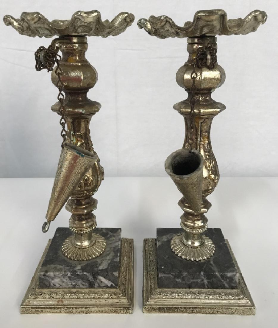 Pair Gold Toned Metal Candlesticks & Snuffers: Lot includes 2 Candlesticks. Appears to be metal and composite, base is possibly marble. Snuffer is cone shaped. Each measures approx 10.5 inches tall 4 inches wide. Tableware, candlesticks decorative