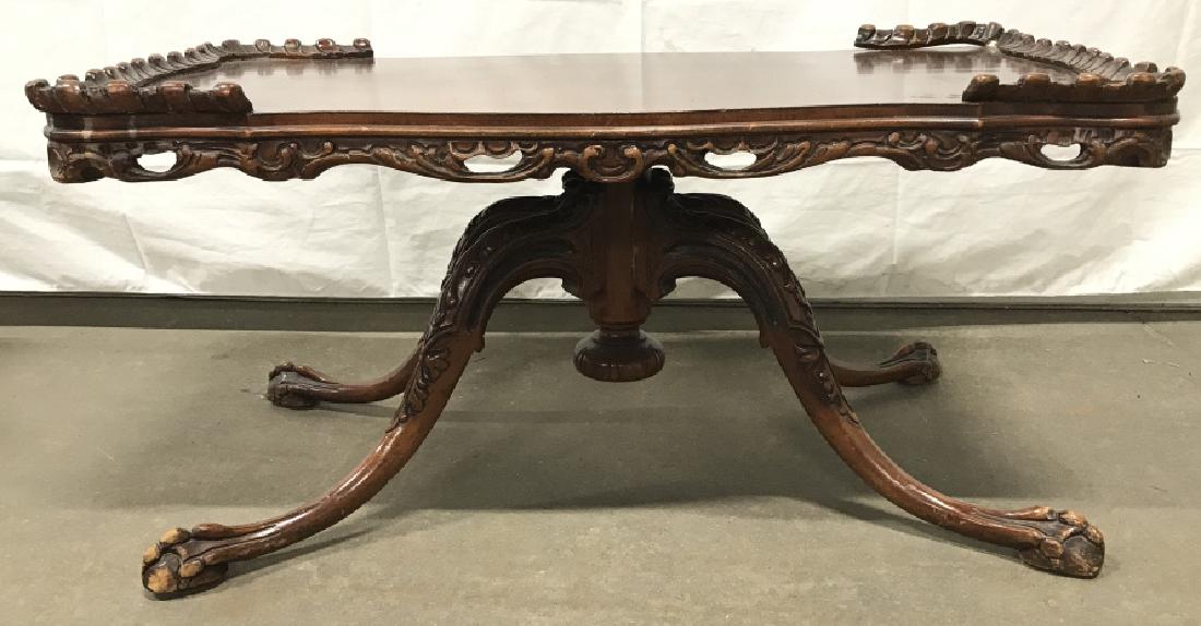Poss Antique Mahogany Toned Claw Footed Table: Poss Antique Mahogany Toned Claw Footed Coffee Table with carved scroll leaf design on table and legs and carved gallery sides. Portion of gallery needs repair, surface wear and scratches throughout d