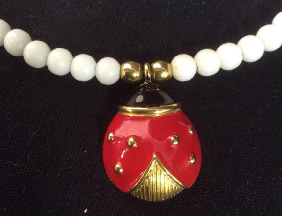Lady Bug Pendant Beaded Necklace: Vintage jewelry, white beaded choker style necklace adjustable size as shown diameter 4.5 inches, with Enameled lady bug pendant measures app 1.25 inches, womens vintage costume estate jewelry