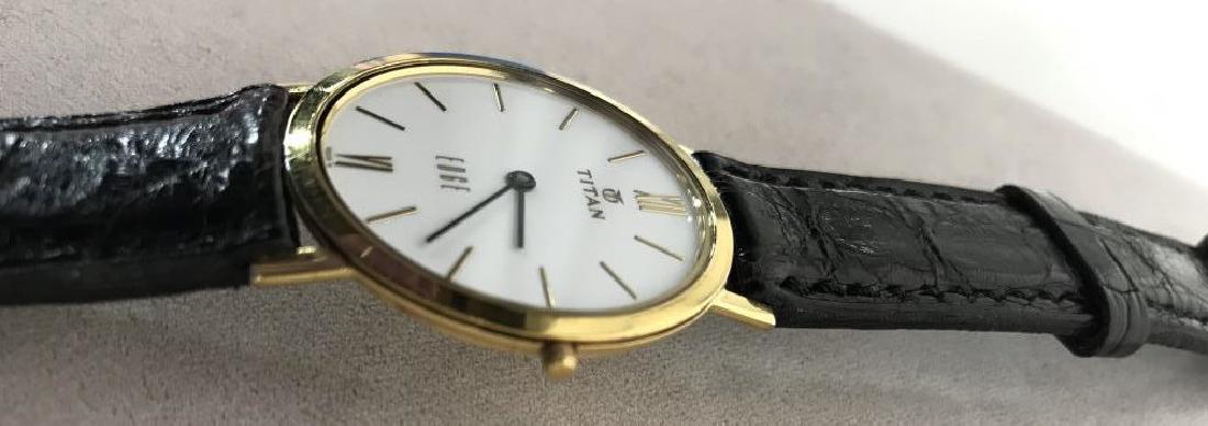 Titan Men’s WRISTWATCH: Titan Men’s WRISTWATCH, with black leather bands, gold toned, white face, marked EDGE, Sapphire Crystal , 30 m Water Resistant, stainless steel, size 18 Omega Band, not tested, Titan men’s Watches