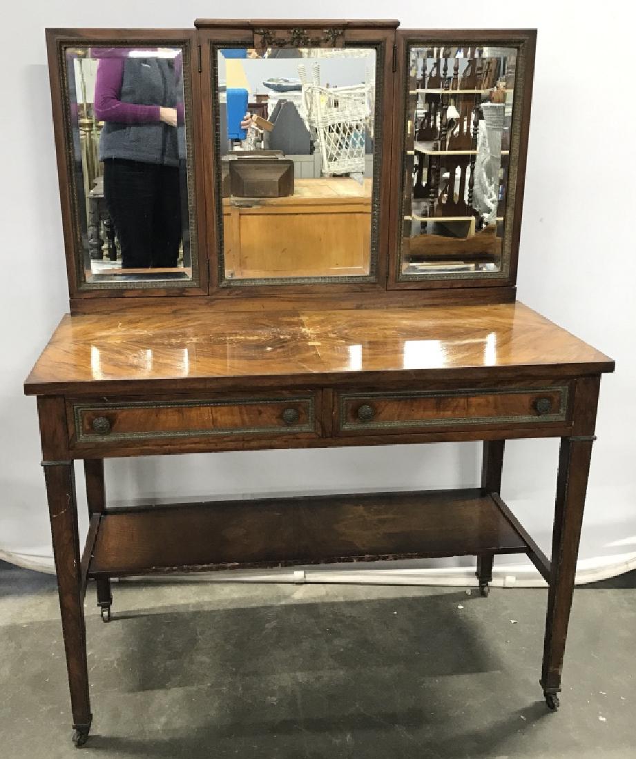 Federal Style Vanity With Mirrored Top: Federal Style Possibly Antique, Possibly Mahogany, Vanity table with three panel mirrored top, wheeled caster feet, and intricate metalwork decorating the piece. Vanity has parquetry top, metal work i
