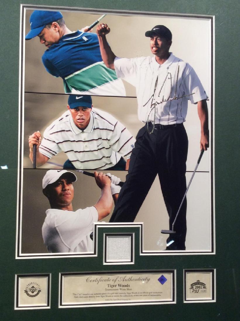 Framed Photo Print & Shirt Of Tiger Woods: Photo prints depicts Tiger Woods along with a 1 x 1 piece of shirt worn by Tiger Woods, with certificate of authenticity. Piece is professionally framed with black toned plastic frame, some scuffs on
