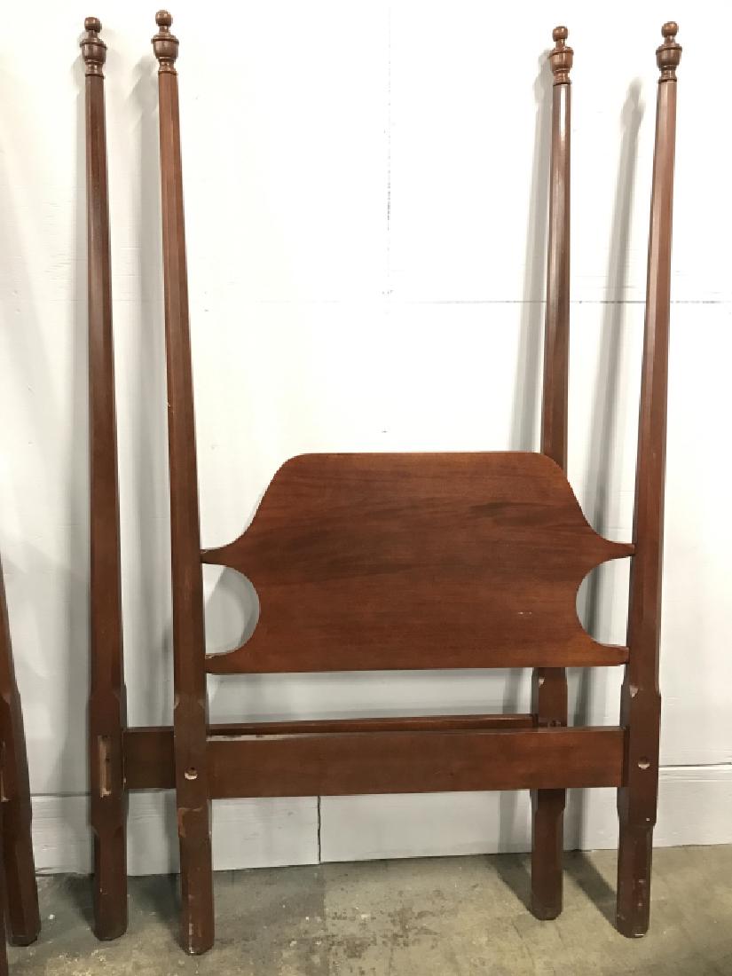 Twin Craftique Four Pencil Post Wooden Bed: Twin Craftique Four Pencil Post Bed in posssibly cherry or mahogany toned wood. Both headboards have sticker that reads Authentic Reproduction by Craftique, inc, Mebane, NC. Property of a Greenwhich,