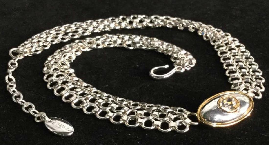 GIVENCHY multi chain & Pendant Necklace: GIVENCHY multi chain pendant necklace. Necklace is silver and gold in tone. Strands attach to center pendant with transparent light caramel tone rhinestone. Metallic Tag marked GIVENCHY and logo on en