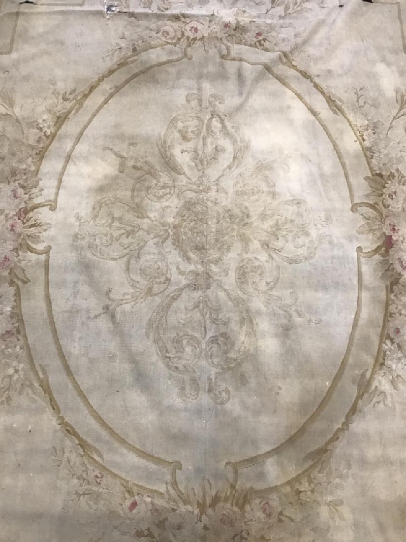 Handmade Antique French Aubusson Rug C 1900’s: Rug is antique. Contains large oval shaped medallion detail in center. Contains intricate floral, leaf, c scroll and vine detail. Contains evident wear, tear, & fading consistent with age. Rug is hand