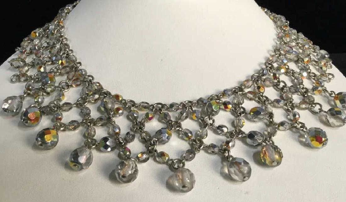 ANNE KLEIN Beaded Statement Collar Necklace: ANNE KLEIN beaded lace-style collar necklace. Tag marked ANNE KLEIN on end of clasp. Necklace is silver in tone with transparent opalescent beads. Vintage Jewelry, statement necklace, costume jewelry.