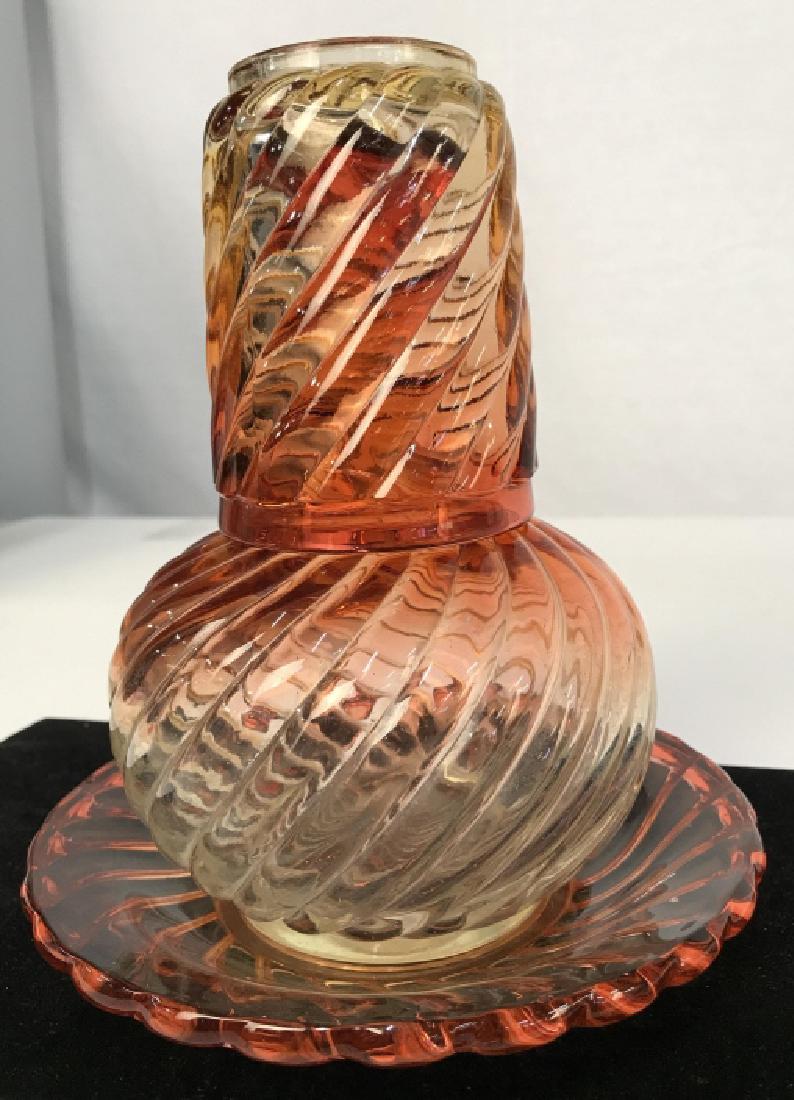 Baccarat Colored Crystal Bedside Set: Baccarat Colored Crystal Bedside Set, includes a dish, beaker and decanter, red and orange swirled glass, Signed Baccarat on base of glass, good condition, plate is 7 in diameter, glass 4 in x 3 in, d