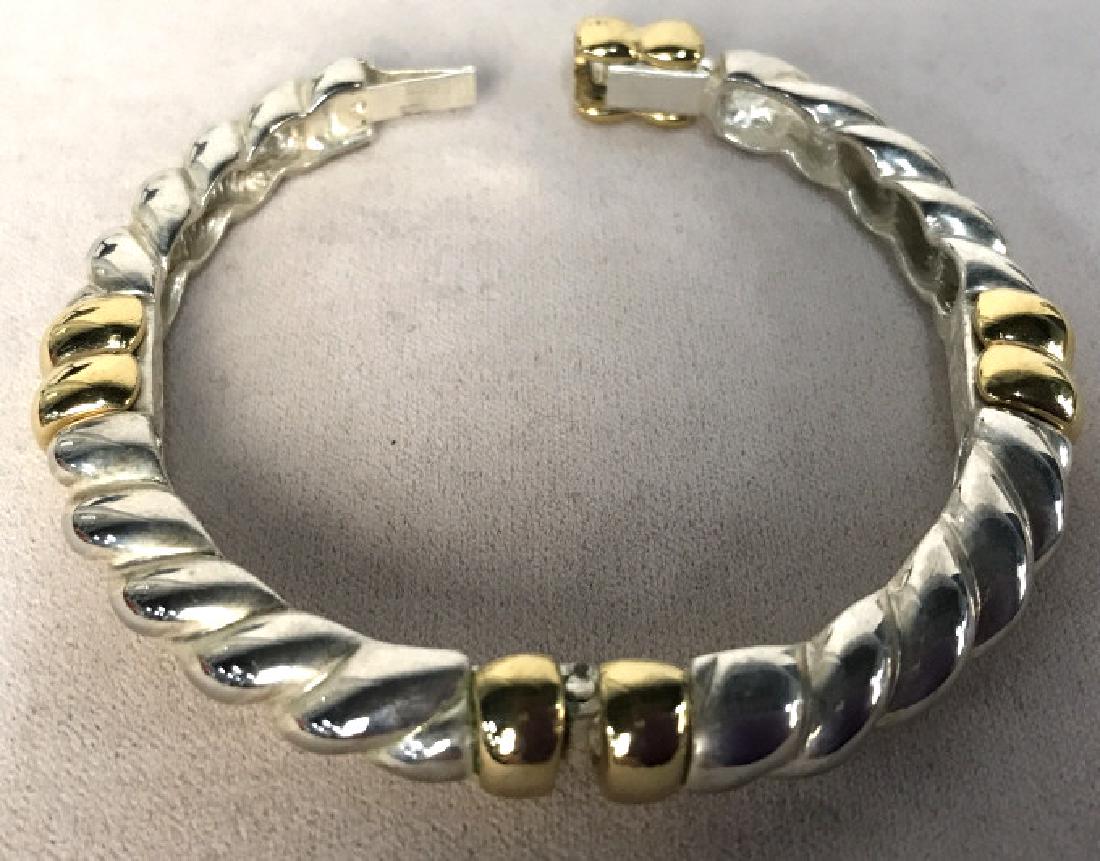 Givenchy Two Toned Twisted Bangle: Givenchy Two Toned Gold Toned and Silver Toned Twisted Bangle, signed on inside Plaque, 2 7/8 in. Diameter, Silver toned metal twised style, to gold toned bands, good clasp, Two sided mechanism, well 