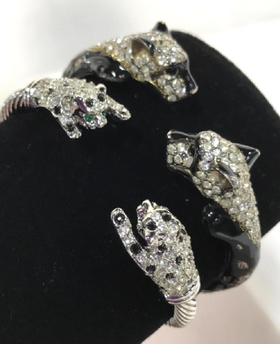 Two Cartier Style Panther Bangles: Two Cartier Style Panther Bangles, 1 white gold toned double green eyed panther heads, 1 black enamel, with rhinestones, black enamel muzzles, each 2 1/2 in diameter, for small wrist, 1 has Jointed op