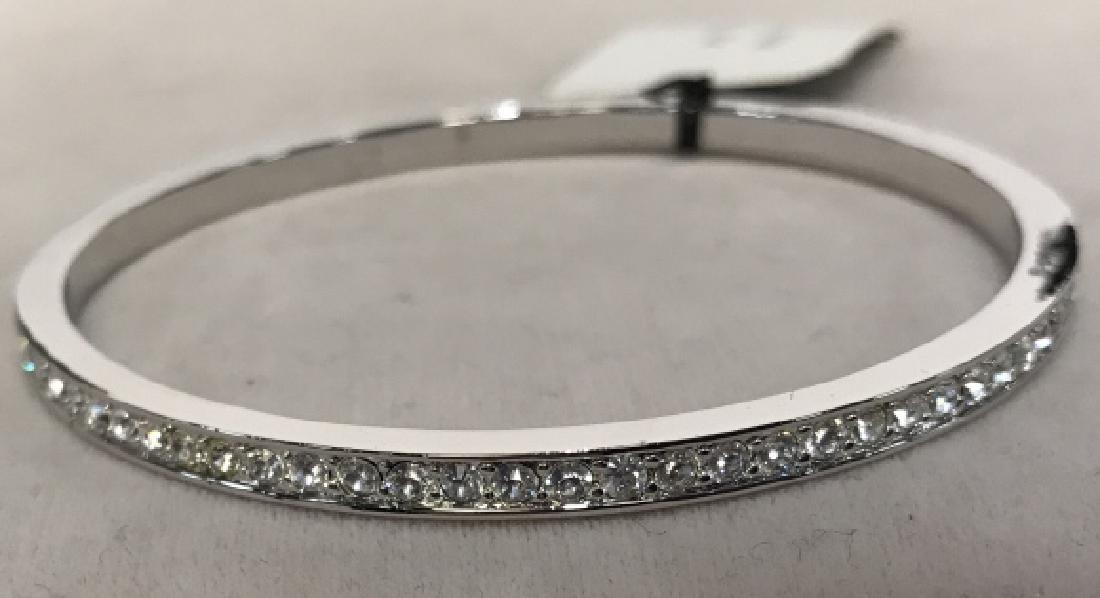 Bijoux Givenchy Rinestone and Platinum Toned Bangle: Bijoux Givenchy rhinestone and Platinum toned metal Bangle, with original tags, set with Round cut Rhinestones set around entire bangle, good condition, 2 7/8 in diameter, Givenchy Signed Costume, Sig