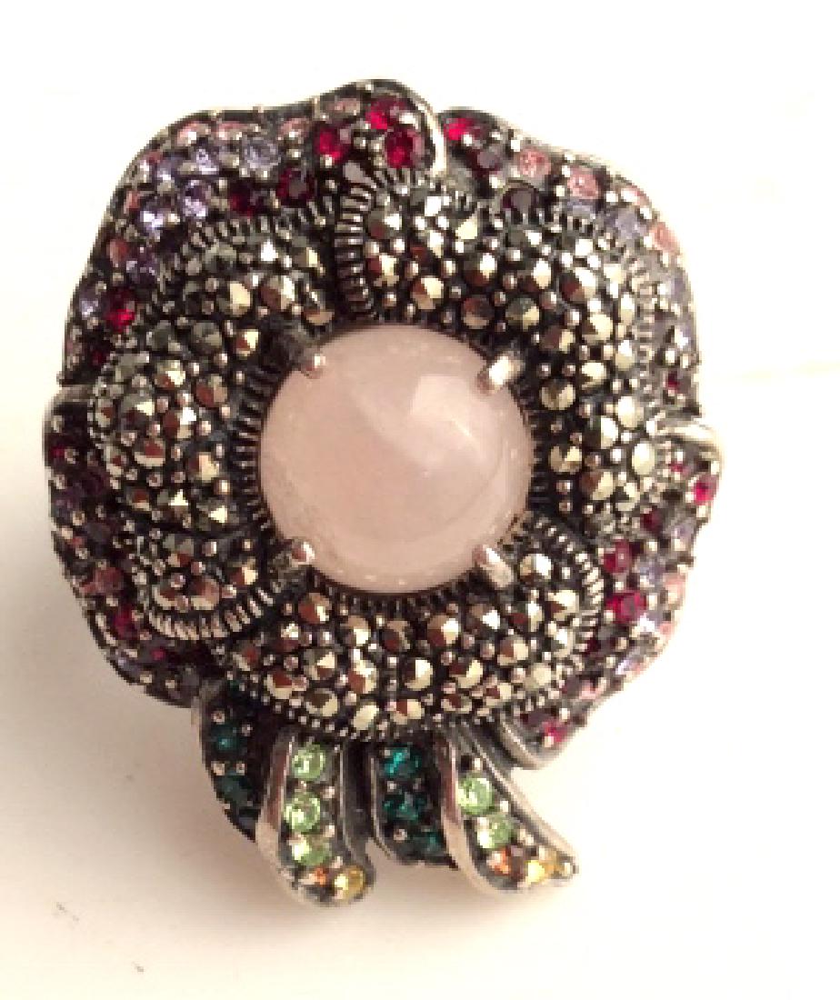 Sterling Silver Floral Design Ring: Sterling Silver Floral Design Ring W multicolored stone inlay. Center is cabochon polished natural stone, possibly pink toned quartz, surrounded with marcasite, also features, red, pink, purple, green