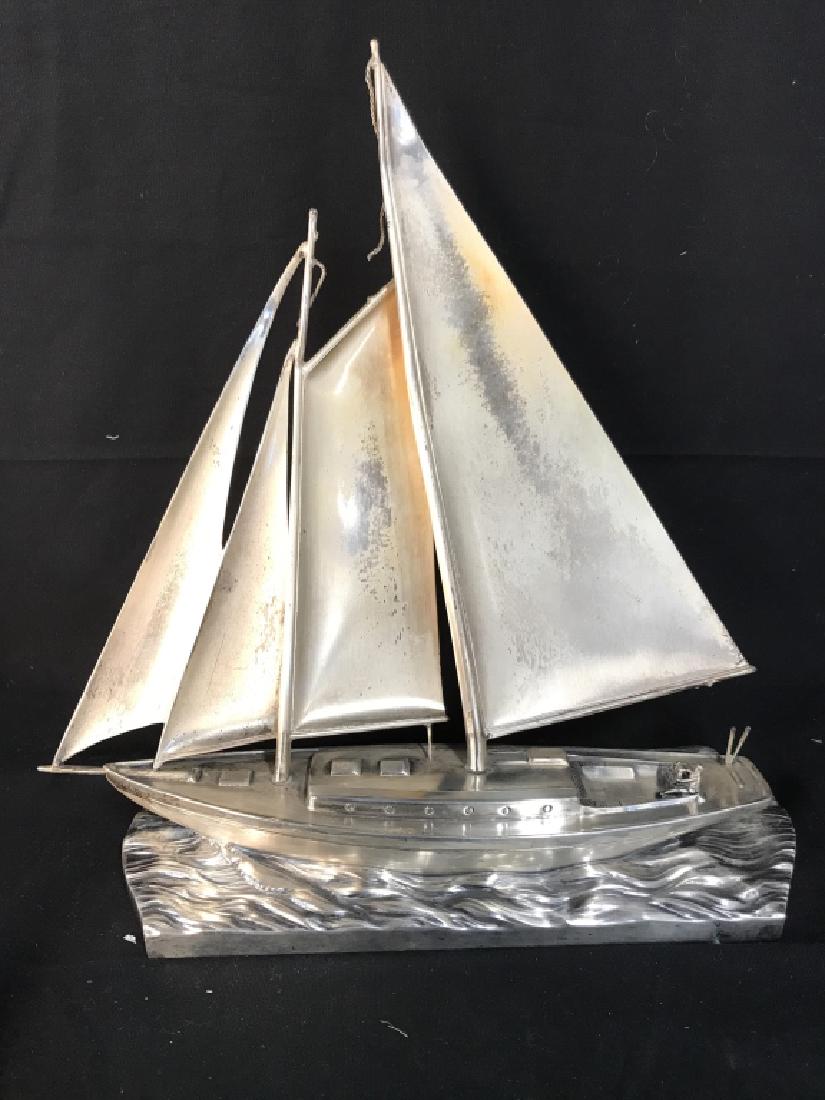 The Jennings Bros Silver Toned Metal Boat Figural: Underside has tag which reads THE JENNINGS BROS. DEPICTS a sailboat. Measures approx 11.5 inches tall and long. Nautical sculpture, maritime collectible, home decor, sculpture,decorative art, decor pi
