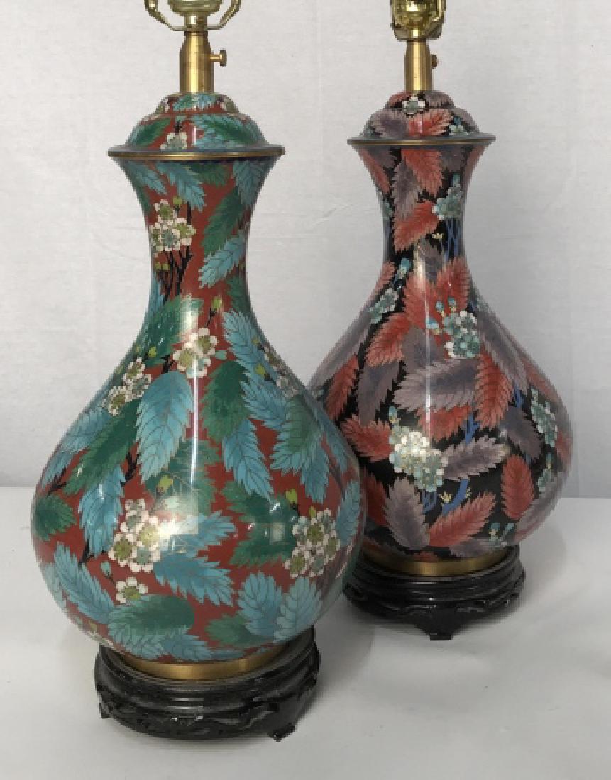 Set of Asian Cloisonné Table Lamps: Set of Asian Cloisonné Table Lamps, each with carved wood stands, decorated with leafy floral designs, one has red ground with turquoise and forest green with cherry blossoms, the other black ground