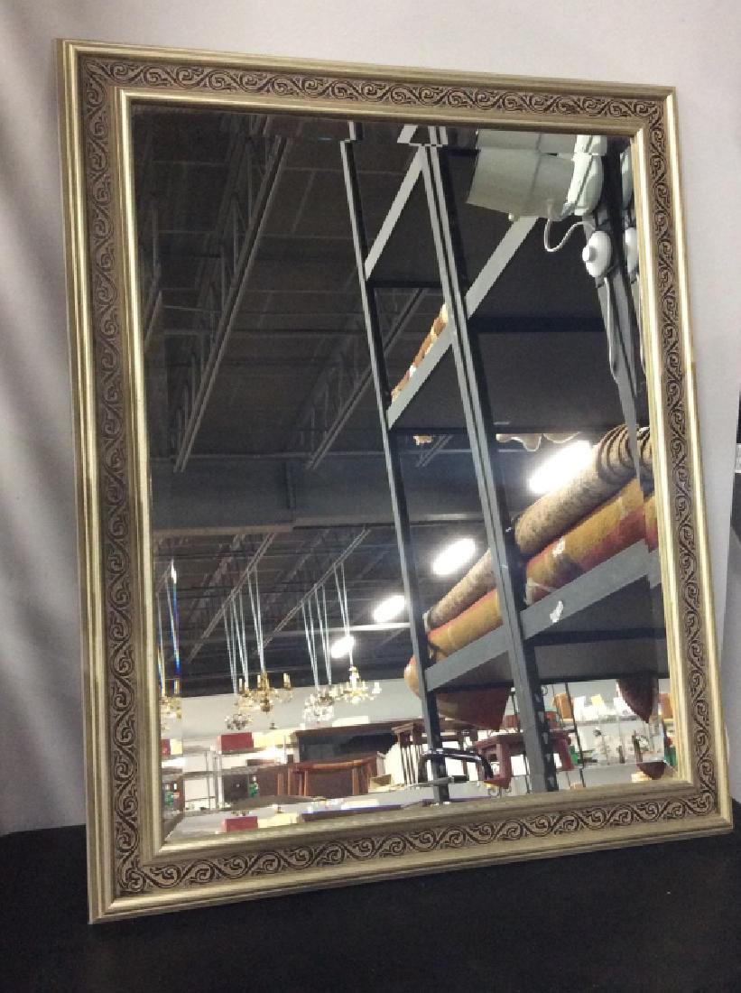 BOMBAY COMPANY Framed Wall Mirror: BOMBAY COMPANY Framed beveled Wall Mirror. Mirror frame is brushed antique silver in tone with black tone floral vine pattern border. Reverse side is labeled for BOMBAY COMPANY, Casetta Mirror. Approx
