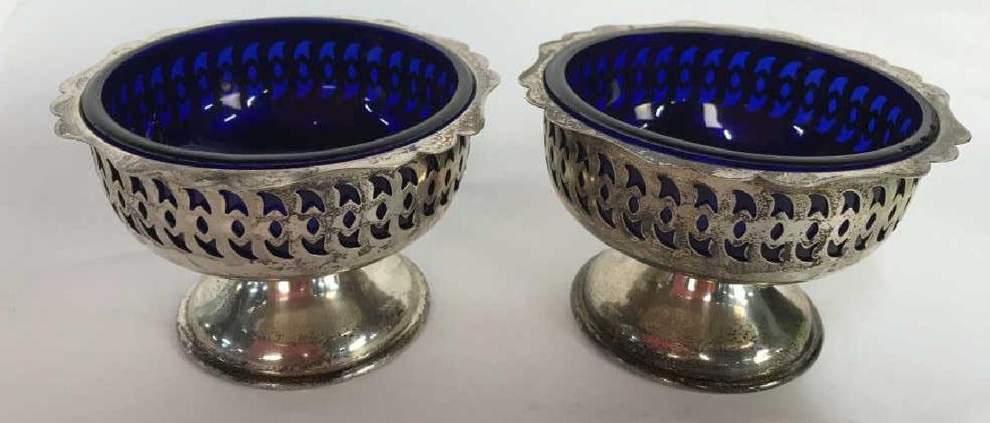 Pair silver Cobalt Blue Pedestal Bowls: Pierced silver plate pedestal bowls with cobalt blue glass inserts, Candy dishes, tableware, table top accessories, each measures ht app 3 inches diameter app 4.5 inches
