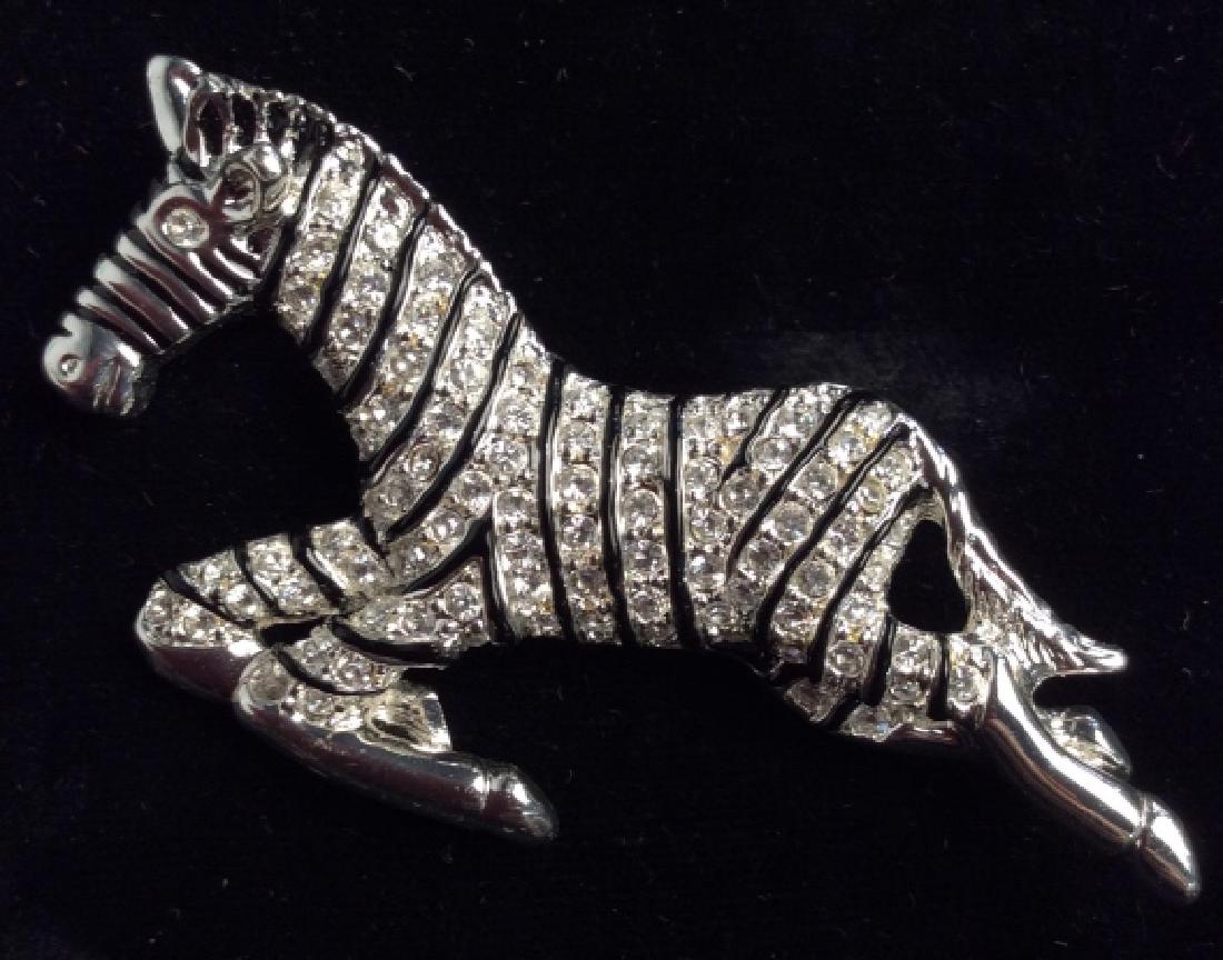 ROMAN Rhinestone Zebra Brooch Pin: ROMAN Rhinestone Zebra Brooch Pin. Zebra Brooch Pin Silver Toned w Rhinestones. Silver toned metal with black toned enamel stripes and rhinestone details. One rhinestone is loose and need some to be r