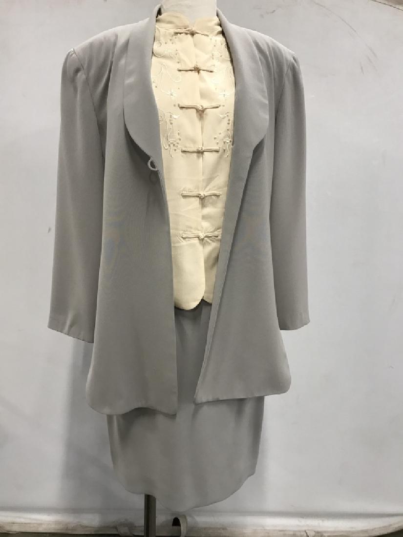 TAHARI Luxury Designer Women’s Suit Ensemble: TAHARI Luxury Designer women’s suit ensemble, including a skirt, inner blouse, and suit jacket/blazer overcoat. Each piece labeled for TAHARI. Each piece labeled for size 12. Suit jacket and skirt a
